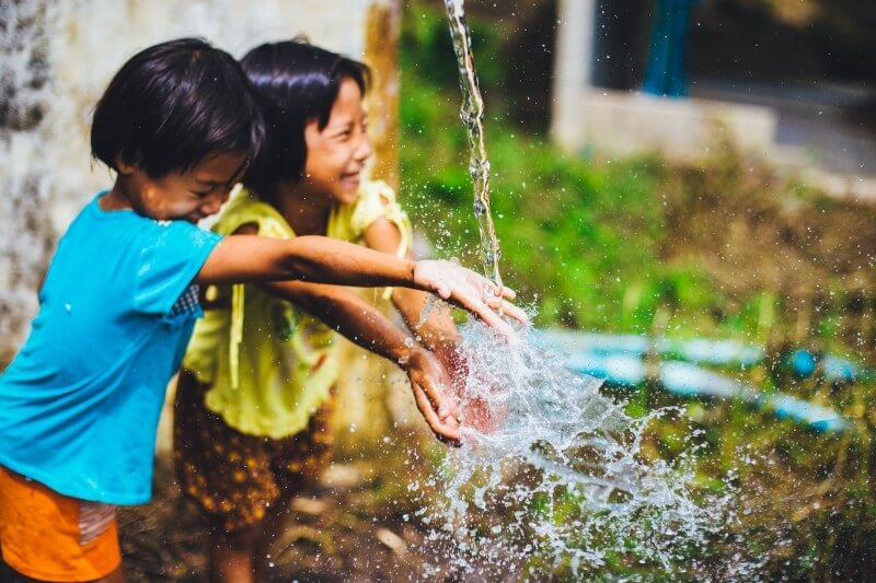 happy-and-smiling-children-playing-with-water
